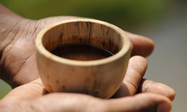Holding wooden cup