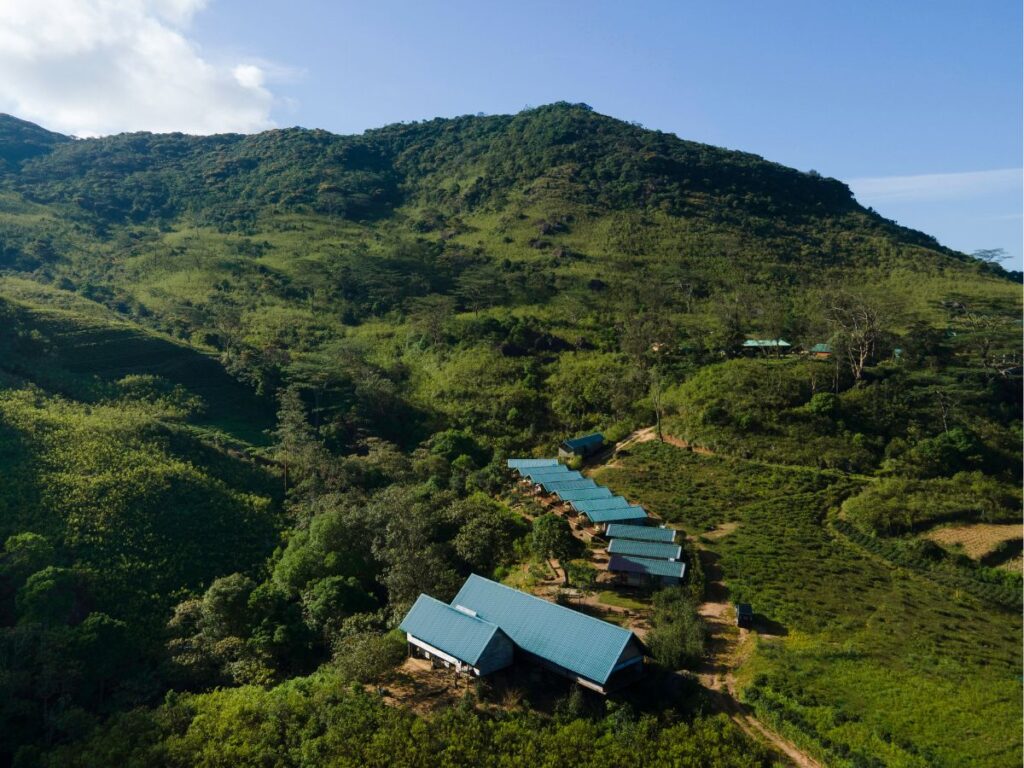 Aerial view of Wild Glamping Knuckles nestled in the lush green hills of Sri Lanka's Knuckles Mountain Range