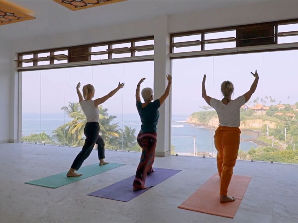 Group of women practicing yoga in a sea-view studio at Ayurvie Weligama, Sri Lanka